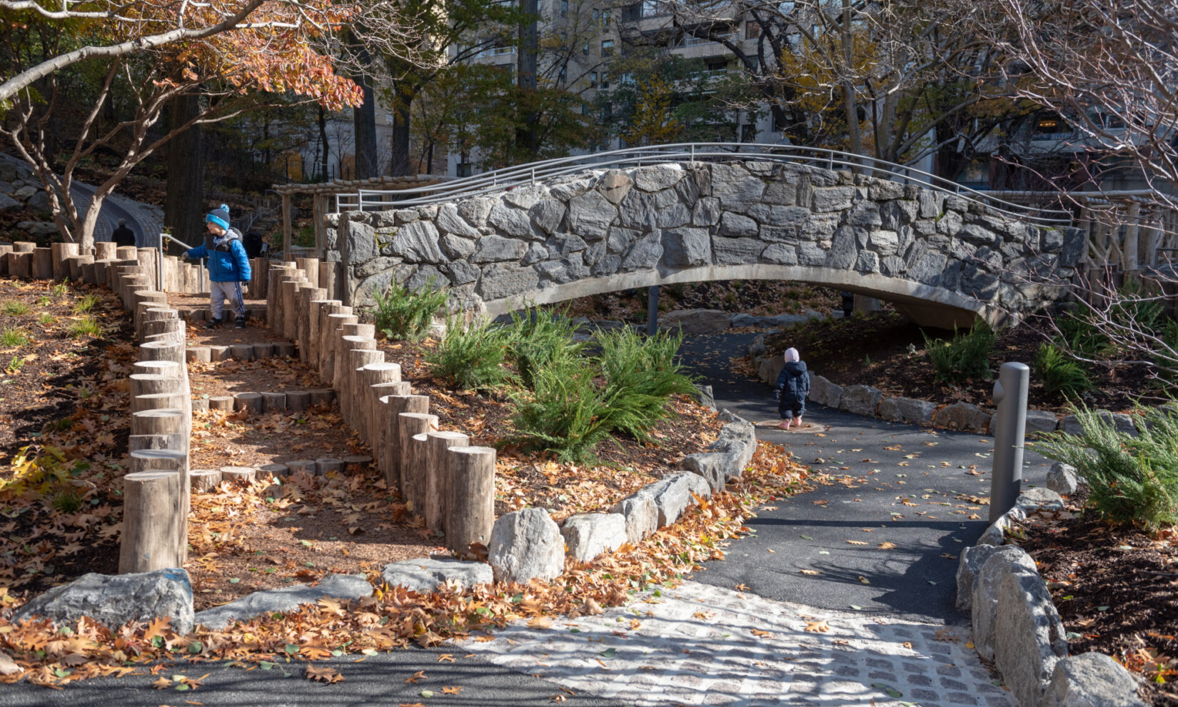 Rustic steps and a stone bridge are highlights of the playground.