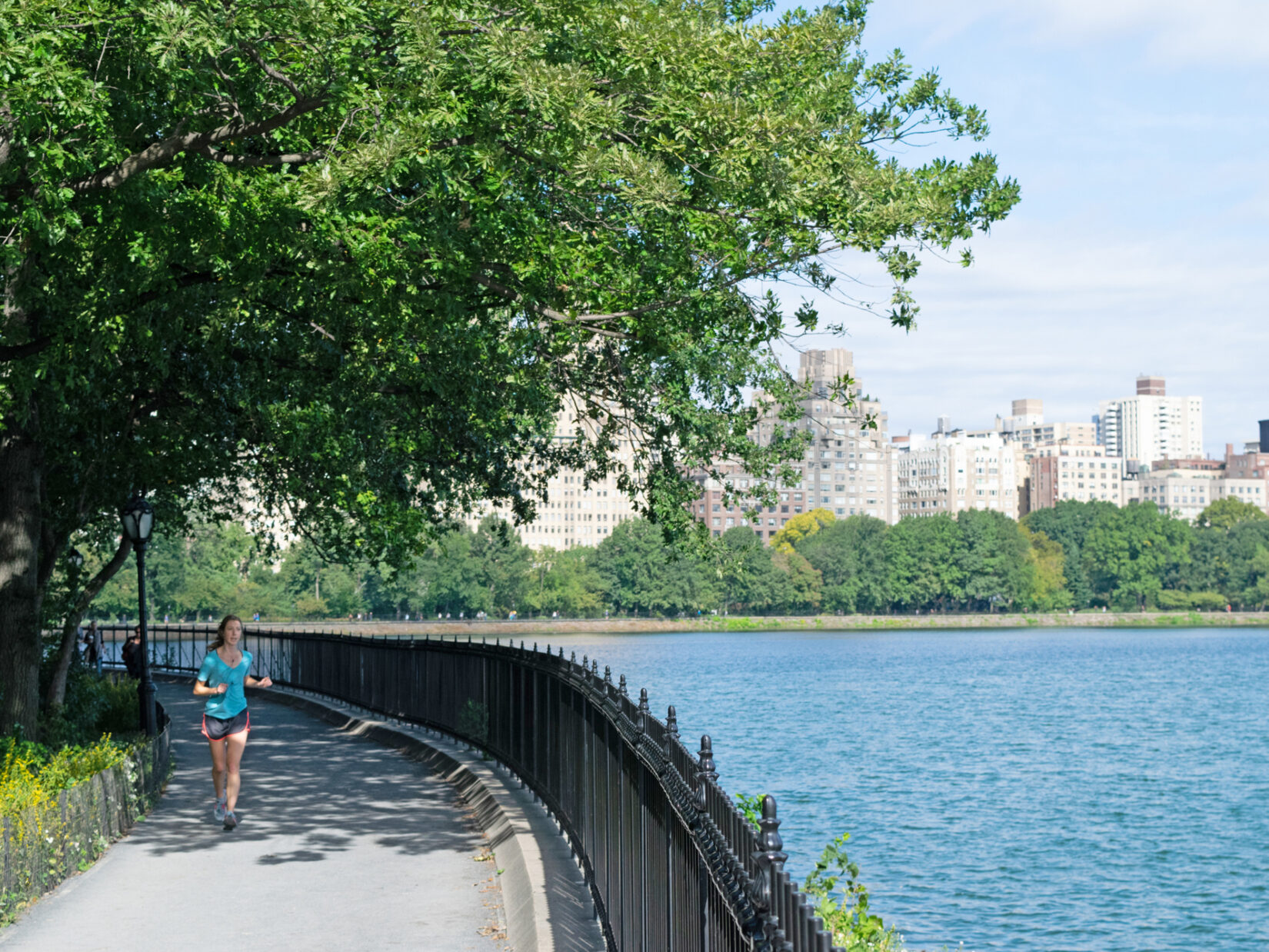 A woman jogs around the Reservoir on the Shuman Running Track