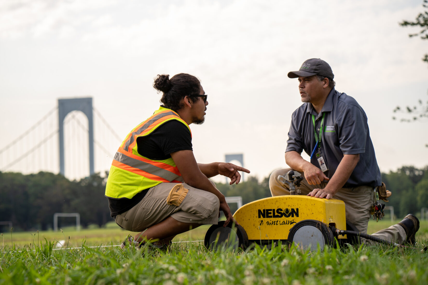 Two groundskeepers at work at Ferry Point