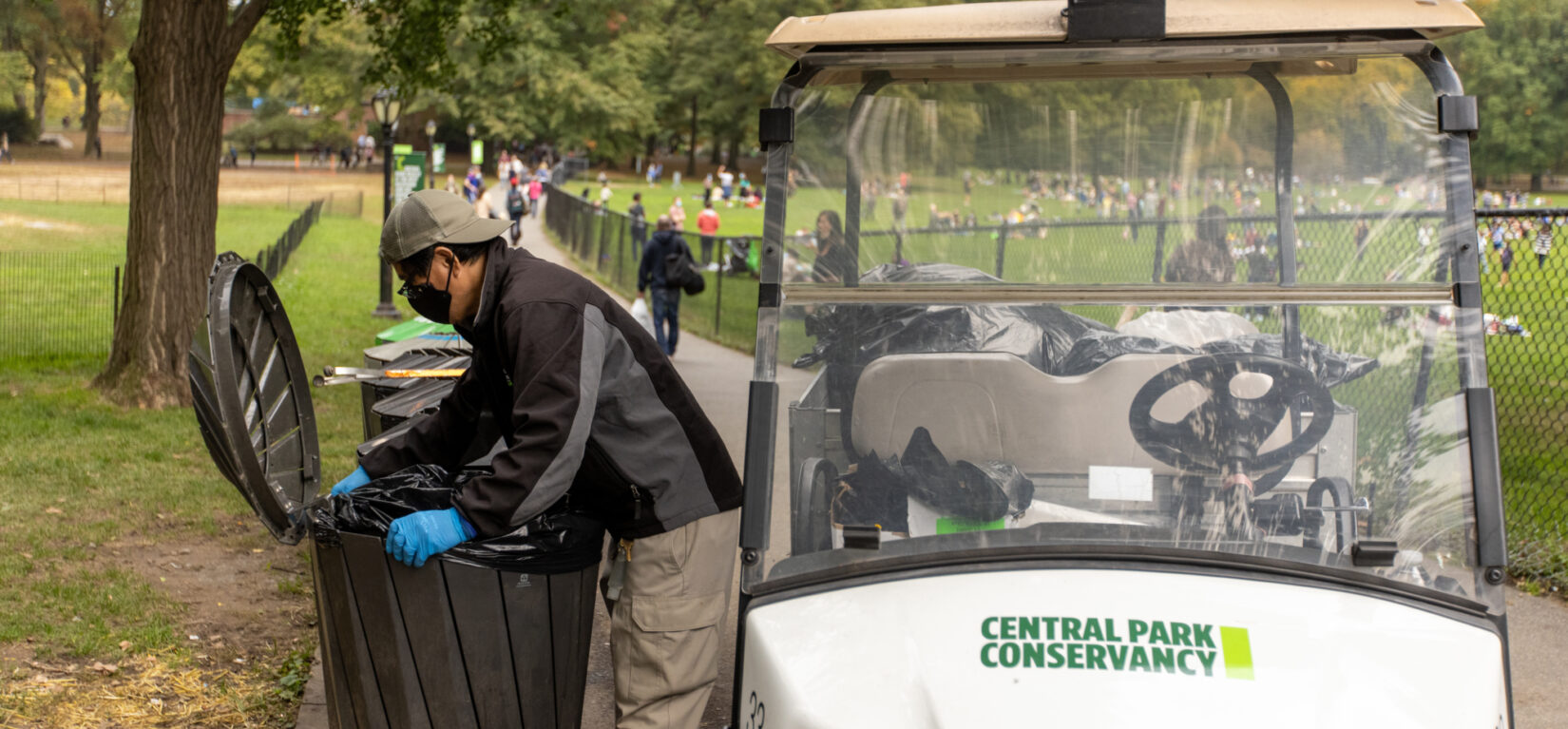 Staff member Danilo Maturan uses an electric cart as part of his trash maintenance routine.