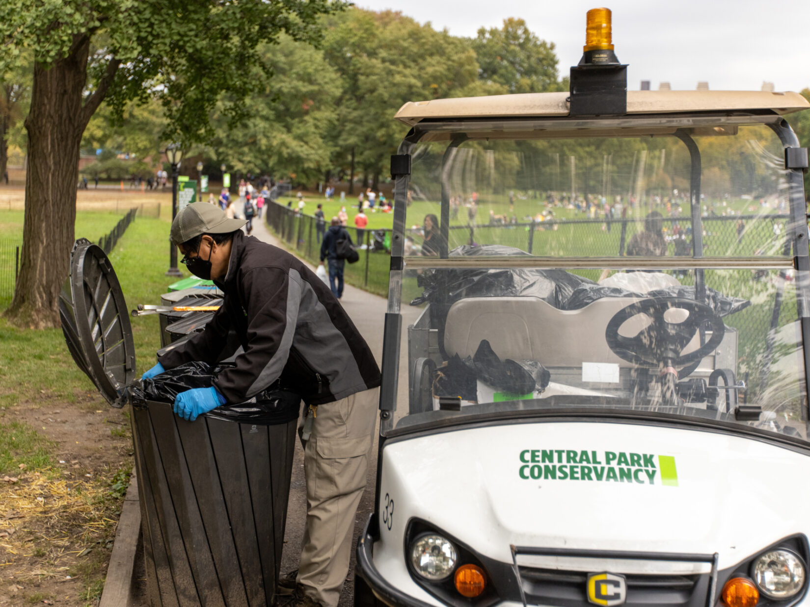 Staff member Danilo Maturan uses an electric cart as part of his trash maintenance routine.