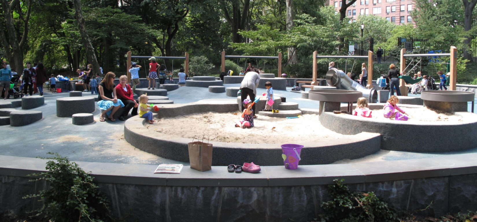 Toddlers enjoy playing in the sand in summer