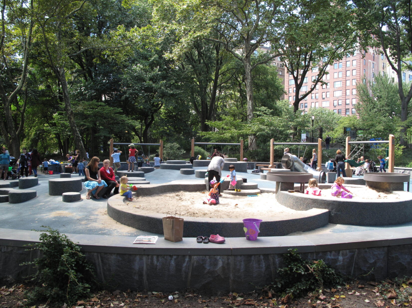 Toddlers enjoy playing in the sand in summer