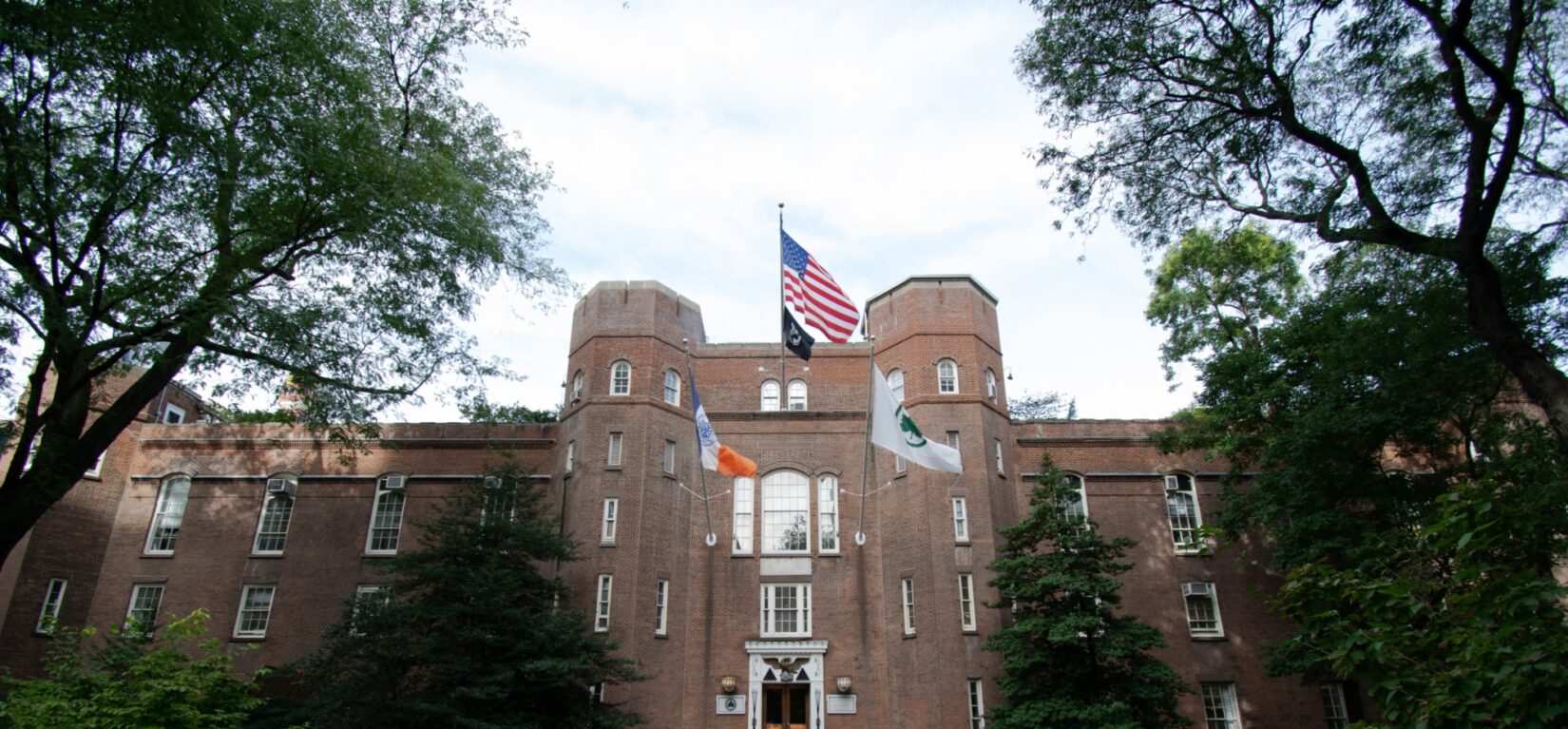 The imposing facade of the Arsenal, with flags waving from three poles