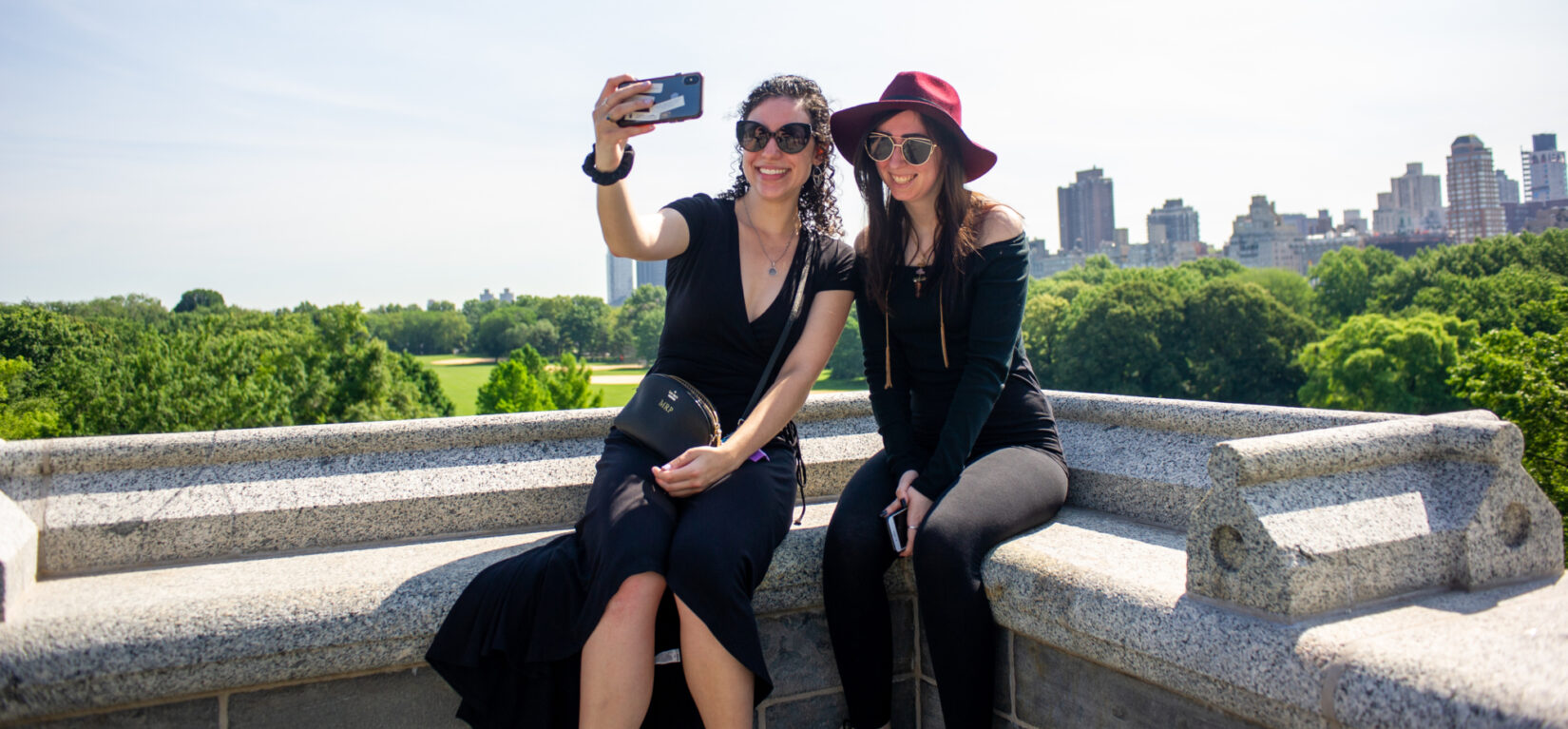 Two young women pose for a selfie atop Belvedere Castle