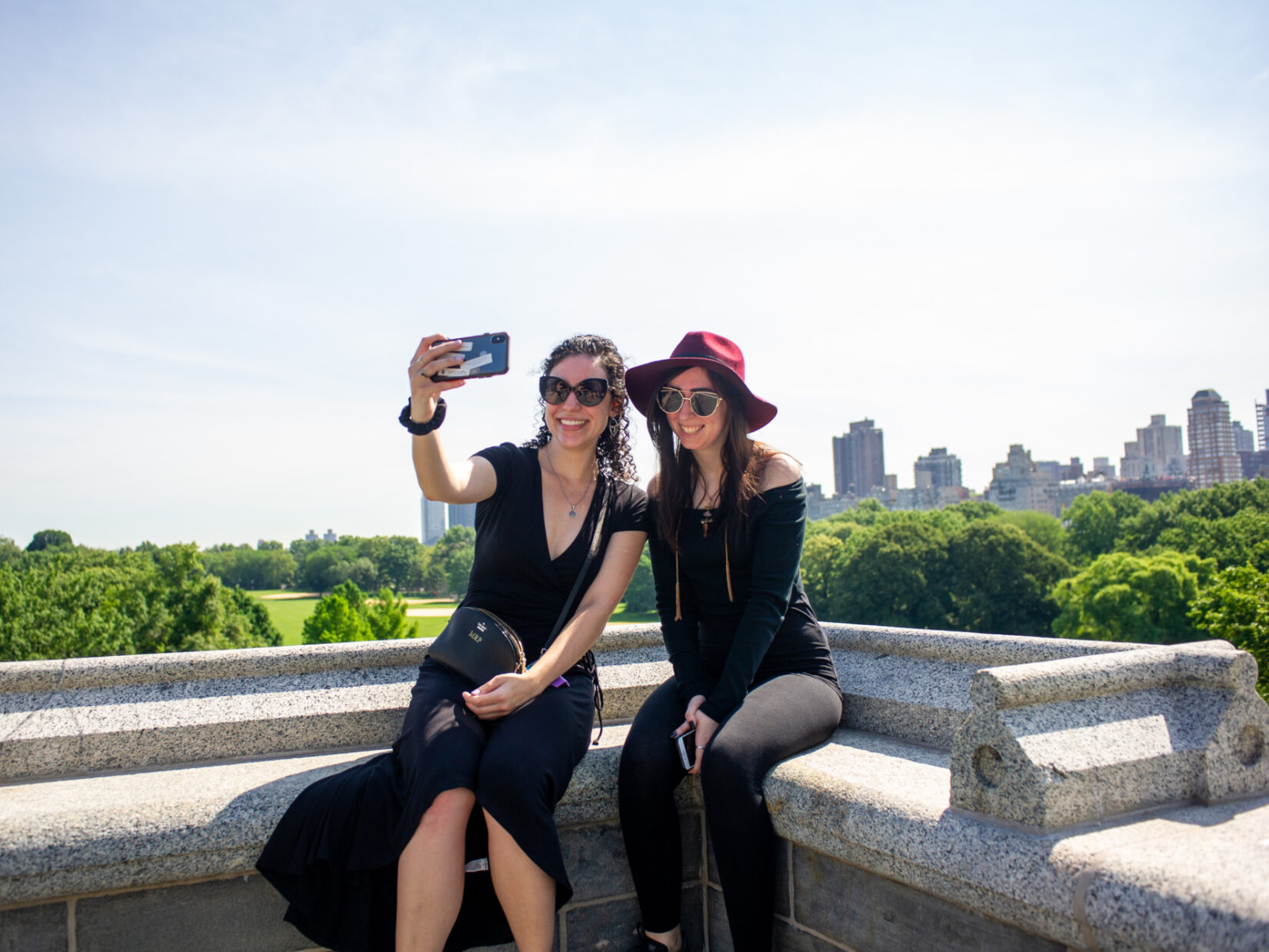 Two young women pose for a selfie atop Belvedere Castle