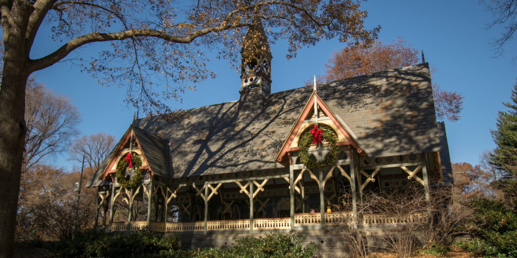 The Dairy shown in autumn, framed by tree branches and landscaping.