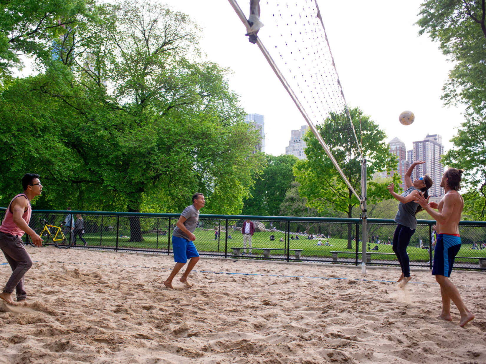 Four players squaring off on the volleyball court