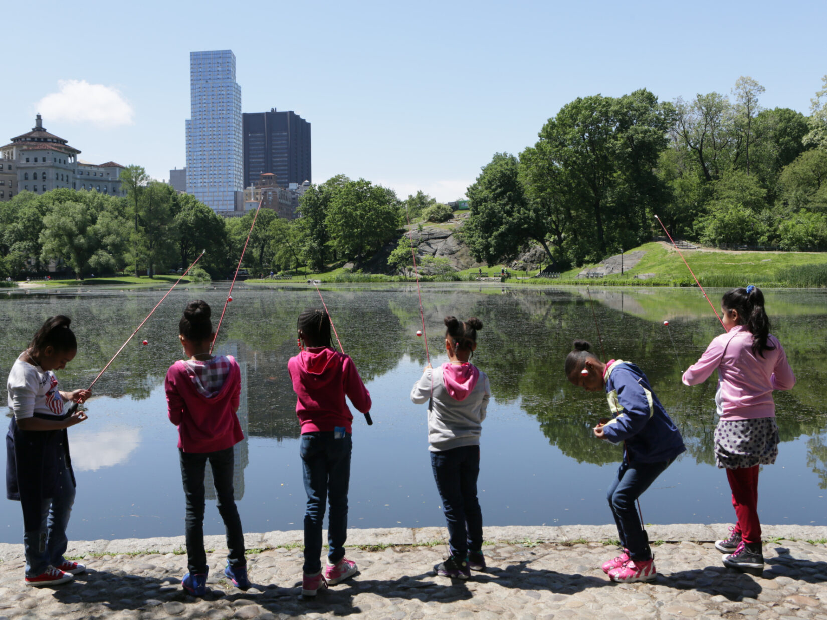 Kids fishing along the Harlem Meer